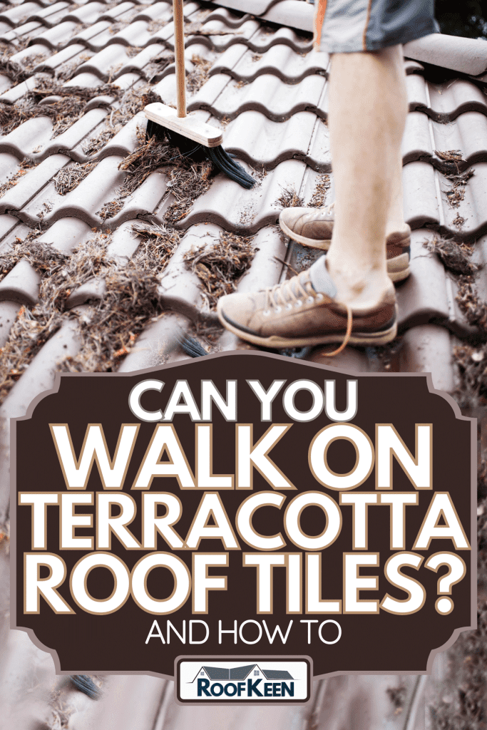 A man cleaning on the rooftop of a terracotta roof tile, Can you walk on terracotta roof tiles?(and how to)