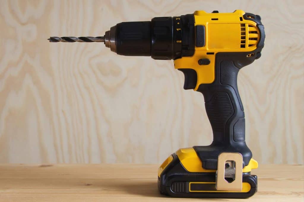 Cordless drill against wooden background