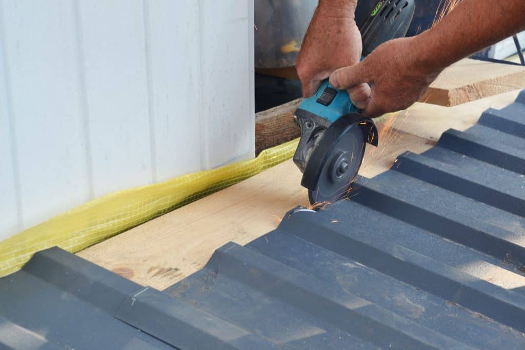 Cutting a black pre-painted roofing sheet