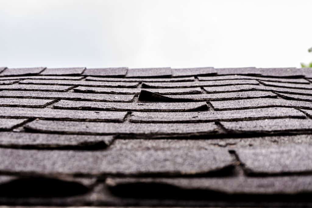 Delamination occurring on the shingle roofing due to water damage