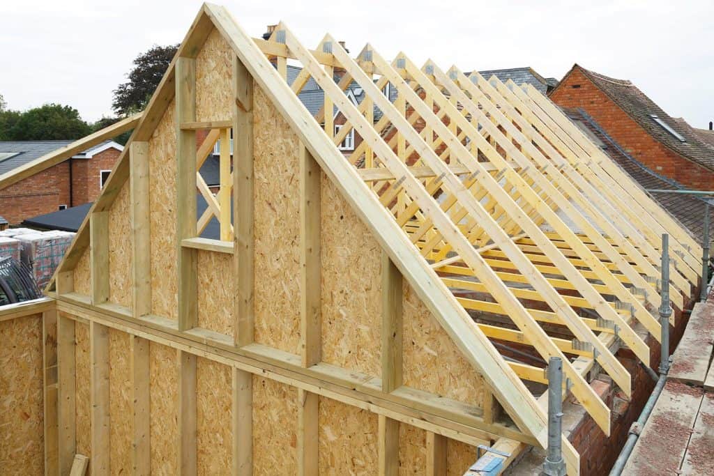 Gable and wooden roof trusses to a timber frame house under construction