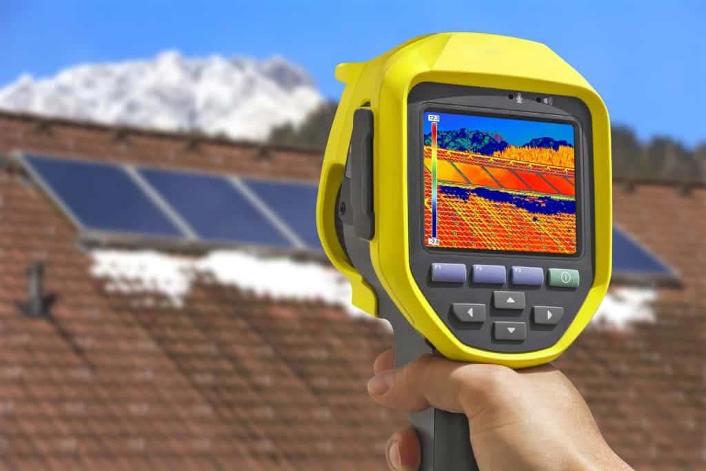 Recording photovoltaic solar panels on the roof house with thermal camera