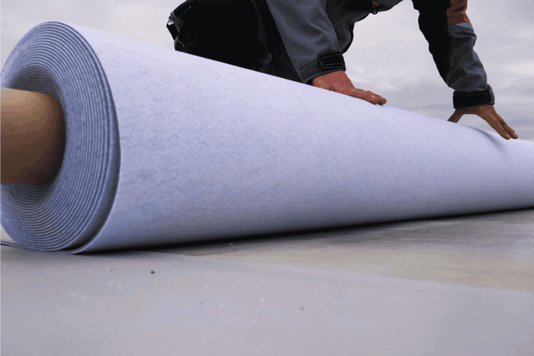 Rolls of polymer coating for the roof. Deployment of a roof covering roll. What Types of Roof Decking Are Used for Low Slope Roofs