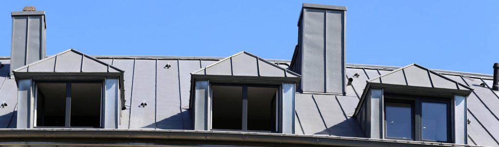 Standing seam metal roof and unfinished windows of a