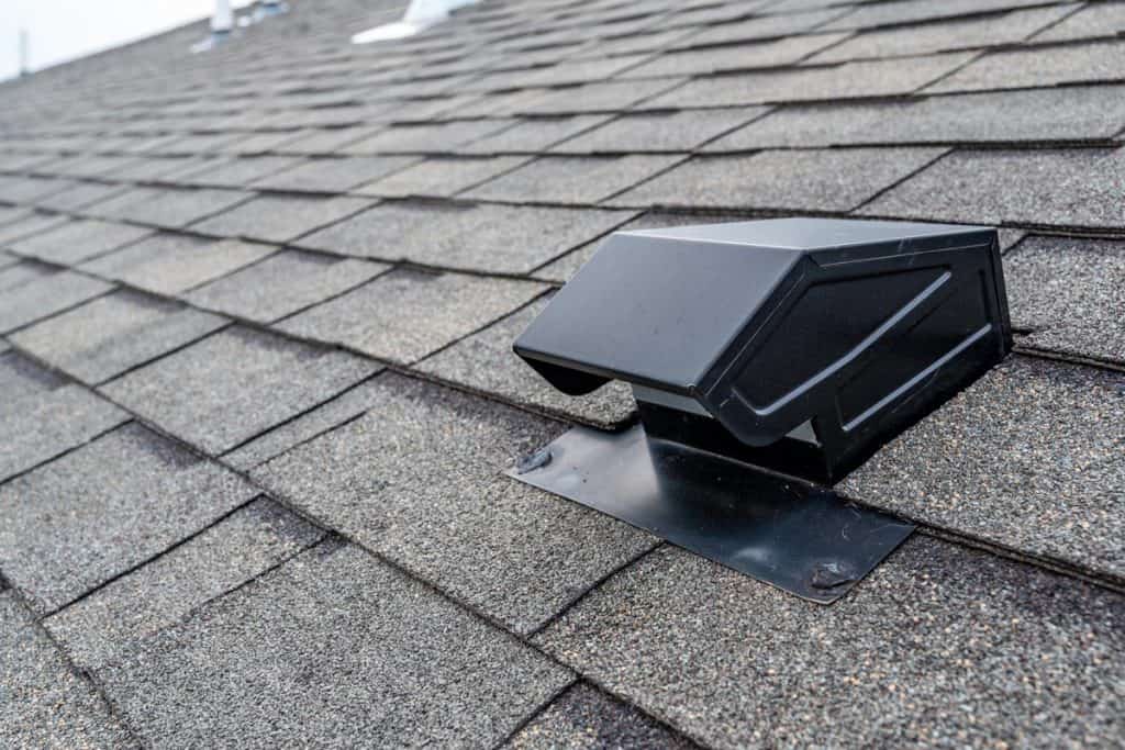 Static vent installed on a shingle roof for passive attic ventilation