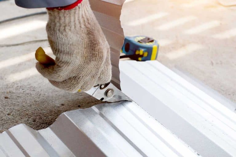 Worker use steel pliers to cut aluminum roof sheets, How to Cut Metal Roofing Around Vents