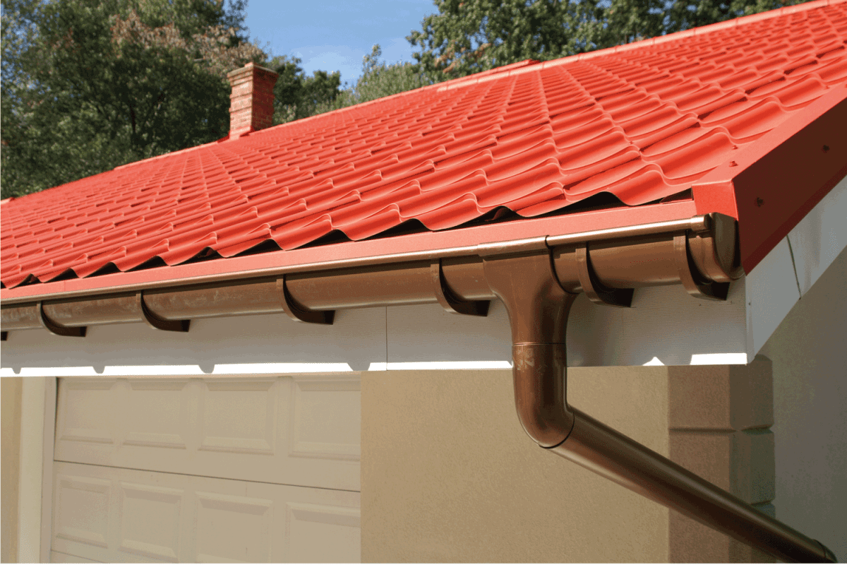 corner of a house with gutters and metal roof