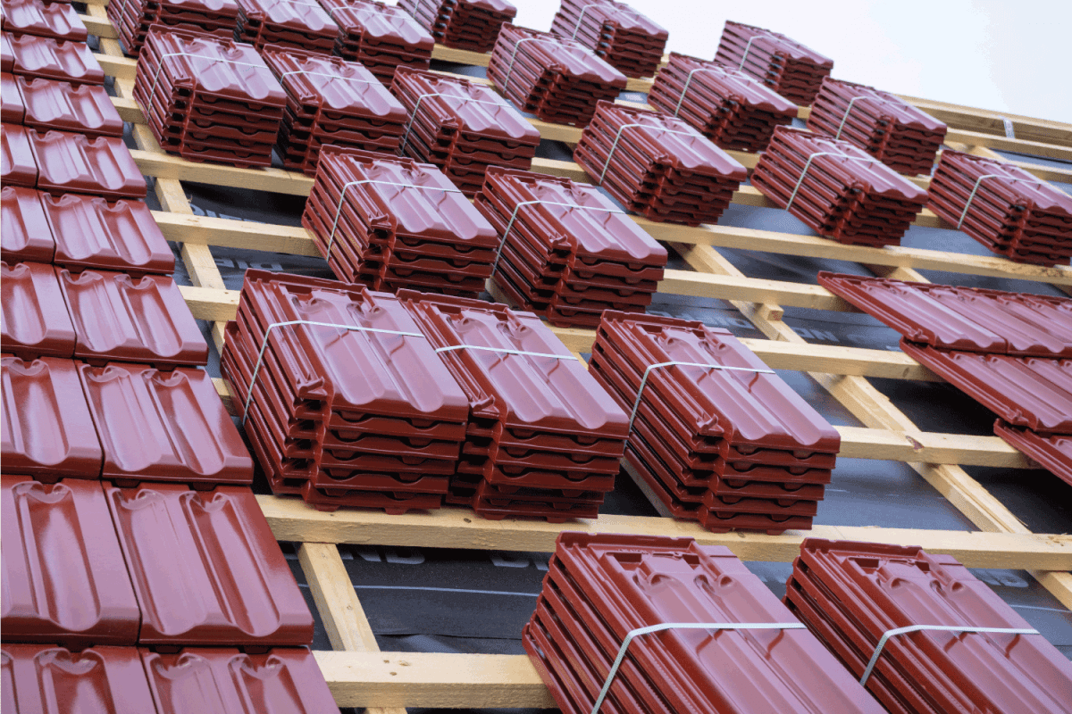 roof under construction with stacks of roof tiles ready to fasten