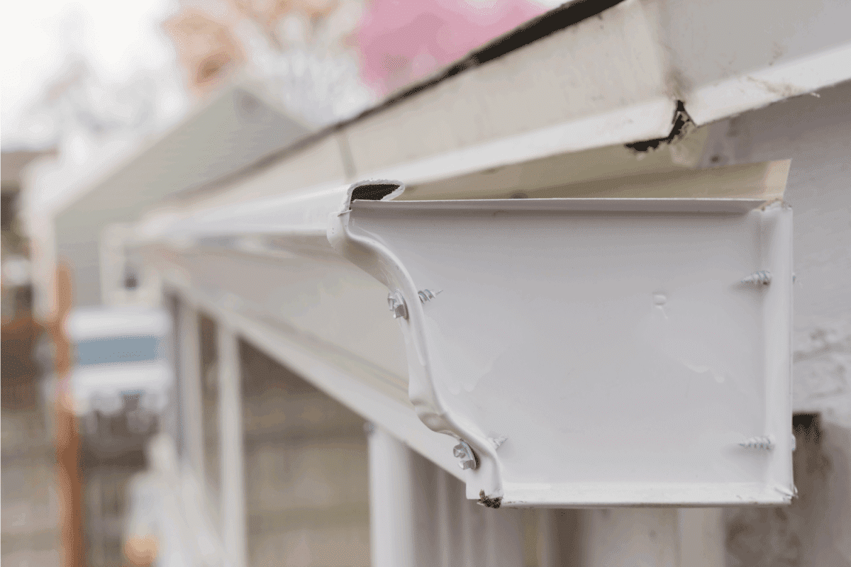 white painted metal gutter with endcap close up