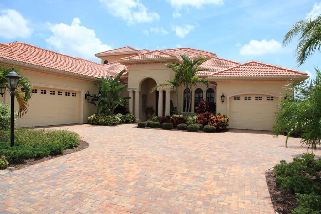 A clay tile driveway of a mansion in Florida with clay tile roofing and stucco wall