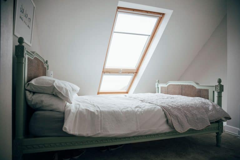 A double bed in an attic under a roof window, What Is The Difference Between A Skylight Or Roof Windows