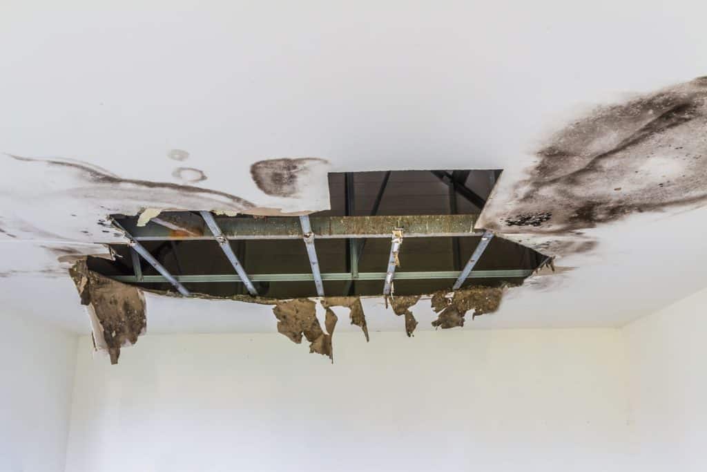 A huge hole in the ceiling caused by water damage