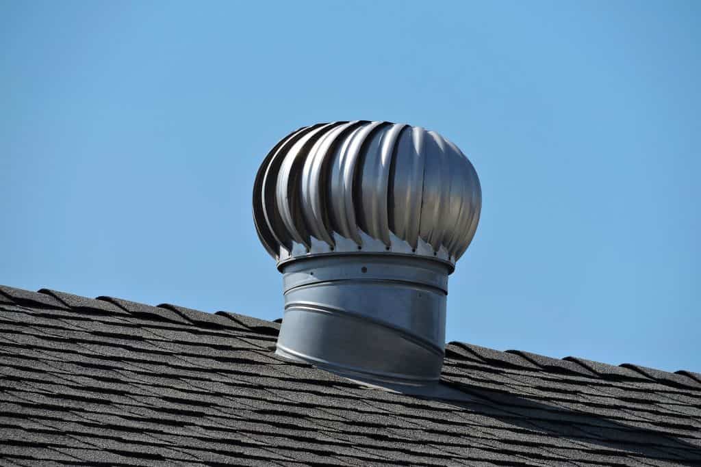 A residential roof vent install on a roof with shingle roofing