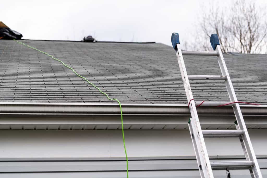 A ladder used in installing a tarp on the roof