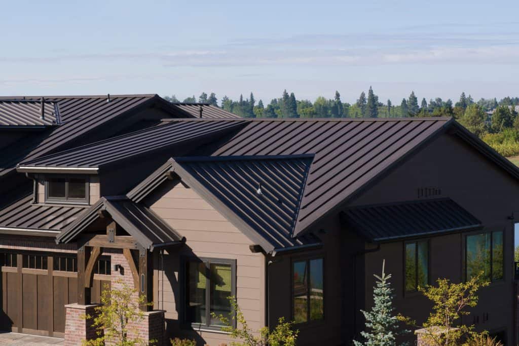 A luxurious and contemporary inspired lake house with brown roofing and brown painted roofing