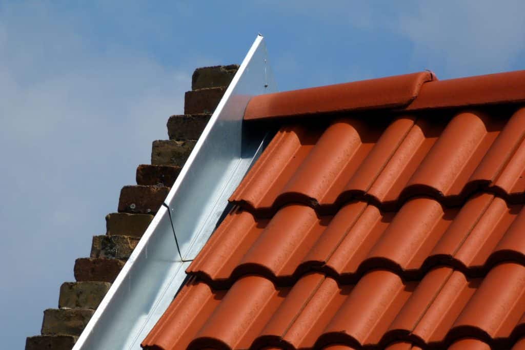 A metal roof tile designed roofing with a stainless steel flashing on the side