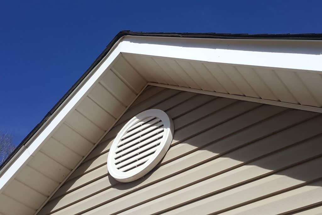 A white gable roof vent