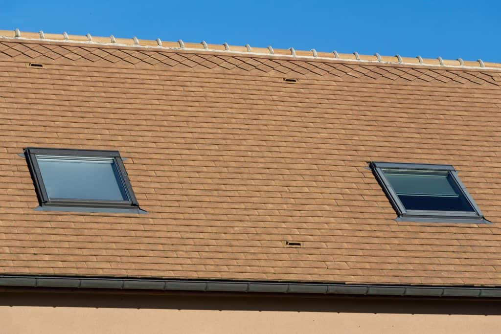 Brown shingle roofing with skylights
