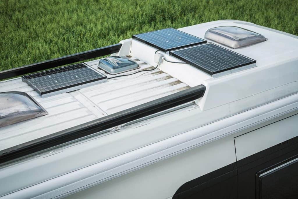 Camper van with three solar panels on top of roof