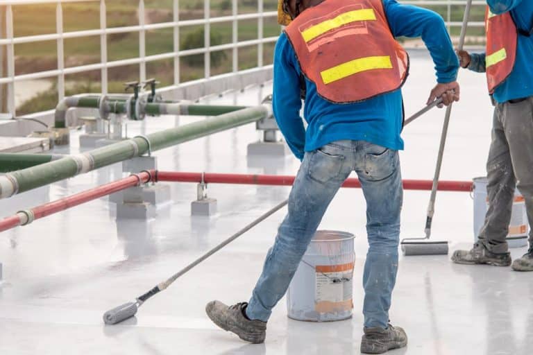 A construction worker coating epoxy paint at roof slab for water proof protection, Best sealer for concrete tile roof