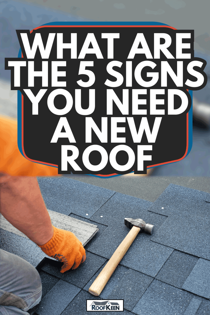 Contractor hands installing bitumen roof shingles using hammer in nails. What Are The 5 Signs You Need A New Roof