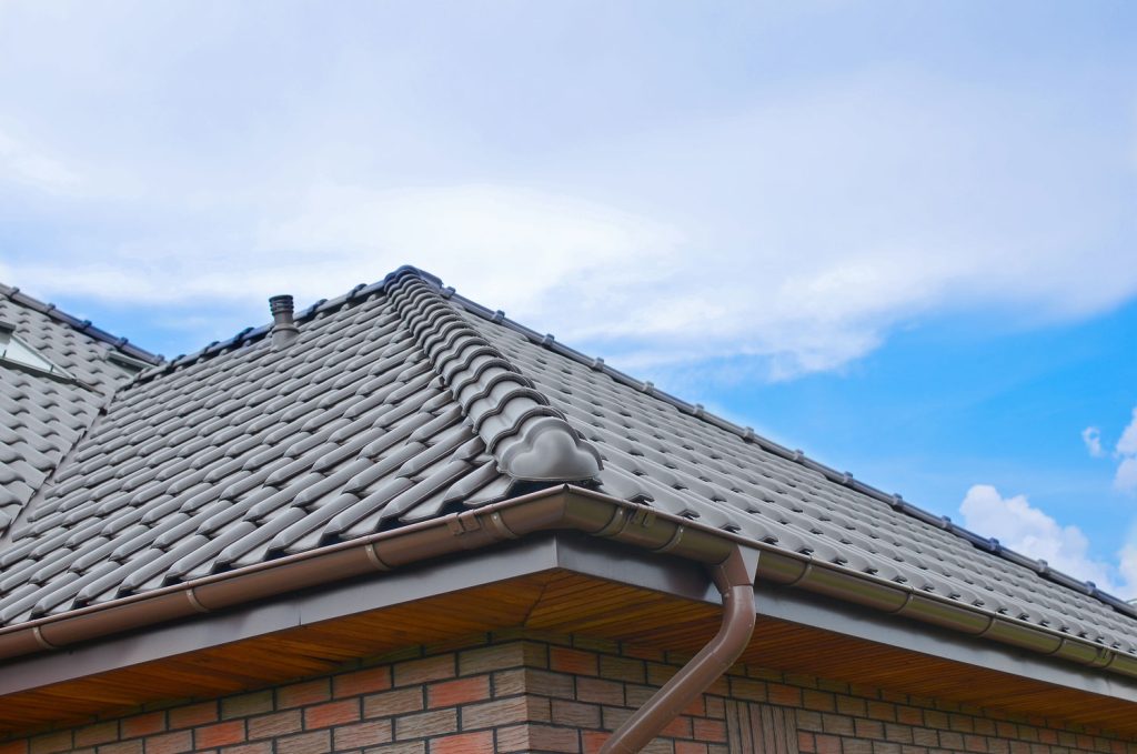 Dark brown ceramic tile roof against blue-sky.