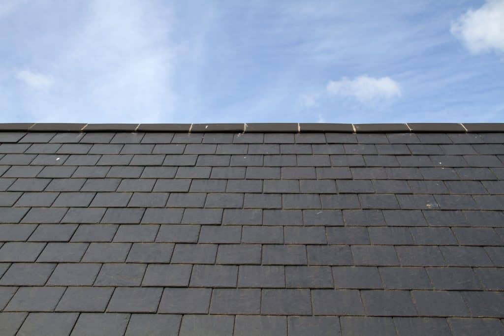 Durable and long lasting gray slate tile roofing with a ridge roll