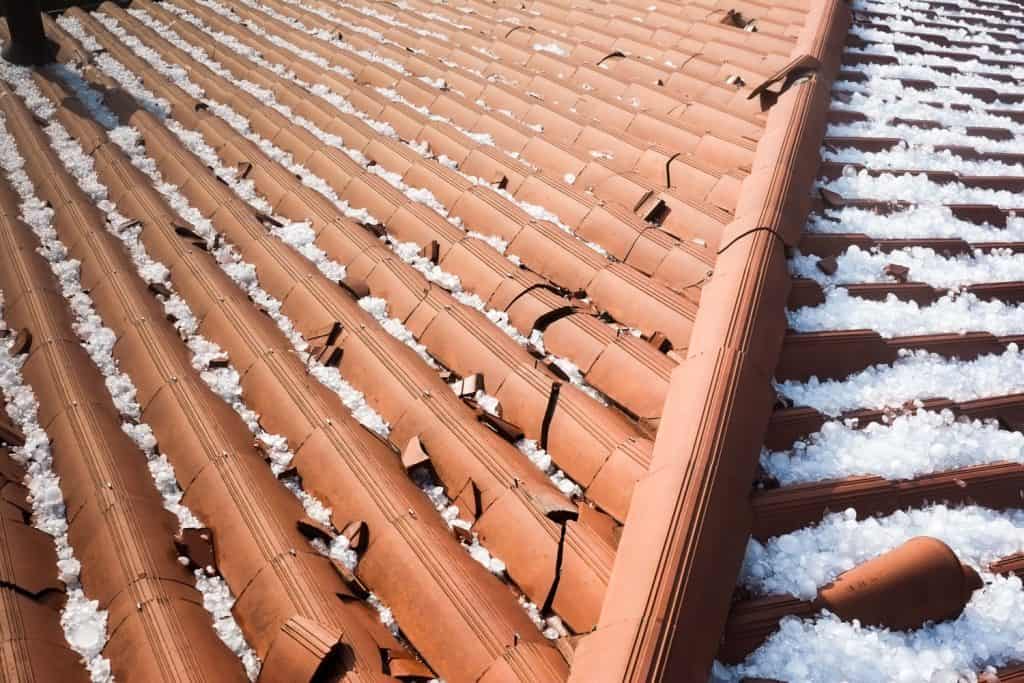 Expensive damage on the clay tile roofing due to a hail storm