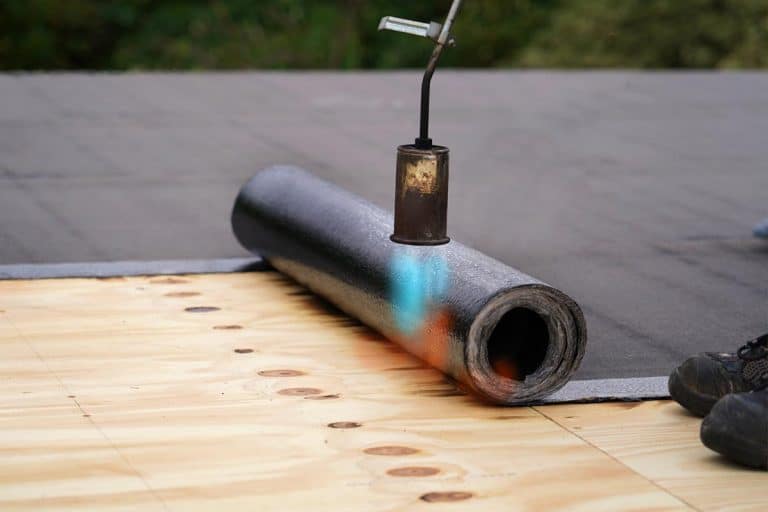 A gas burner and a roll of tar paper, Flat Roof Materials: Which is The Best?