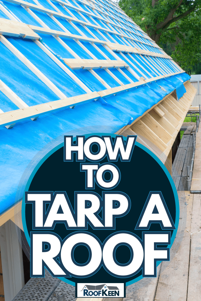 A blue tarp covered over a house undergoing construction, How To Tarp A Roof