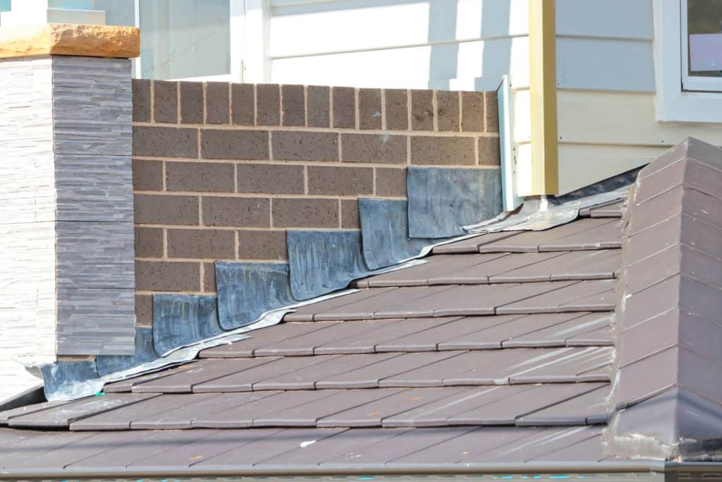 Metal sheet roofing with flashing on the side