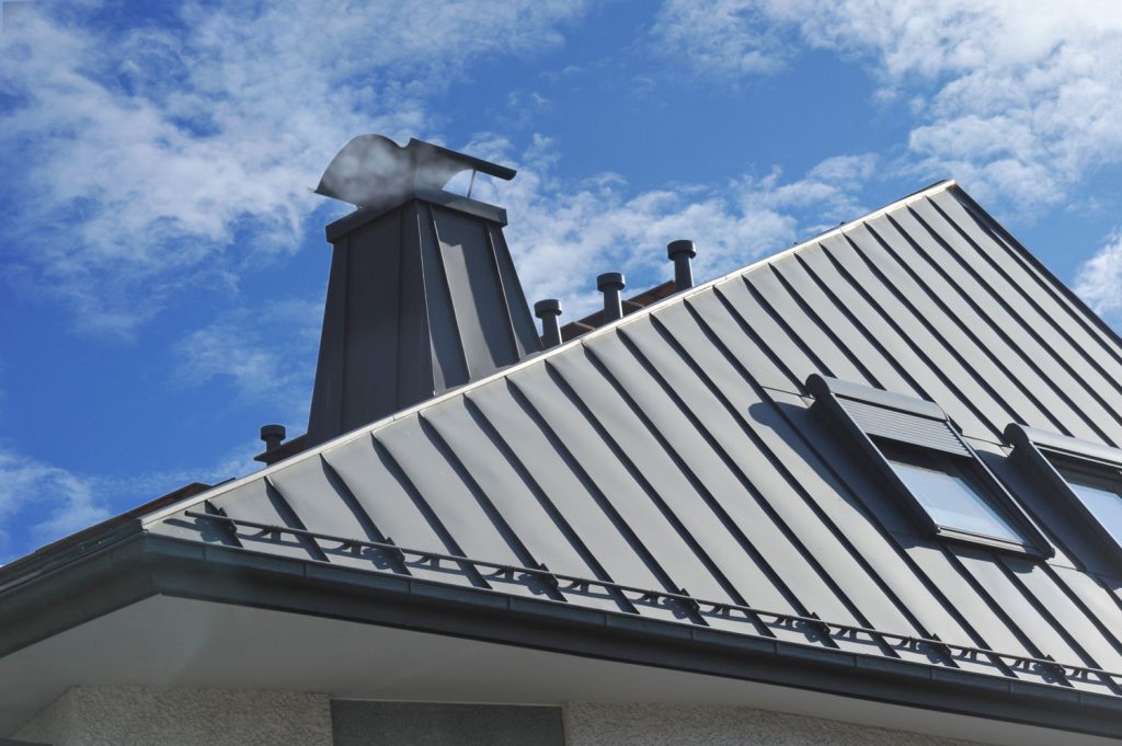 Modern Standig Seam Metal Roof with Roof Window, Fume Hoods, Snow Guard, rain Gutter and Metal plastered Chimney