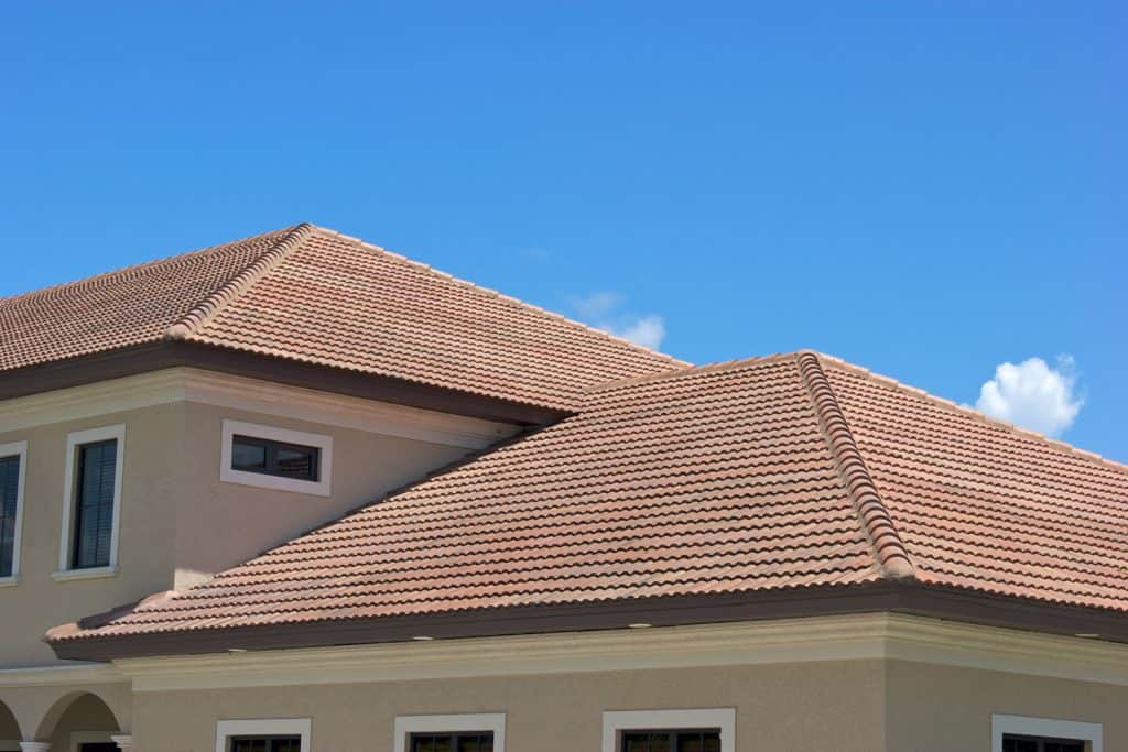Properly laid out clay tile roofing of a house with stucco exterior walls