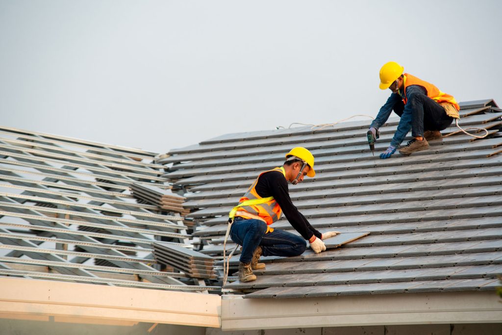 Roofer worker in special protective work wear and gloves