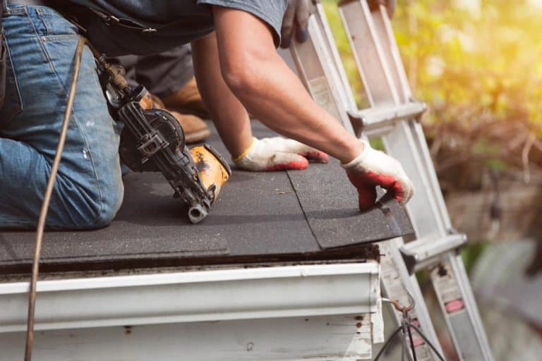 A roofers installing a new roof on residential home, How often should you replace your roof shingles?