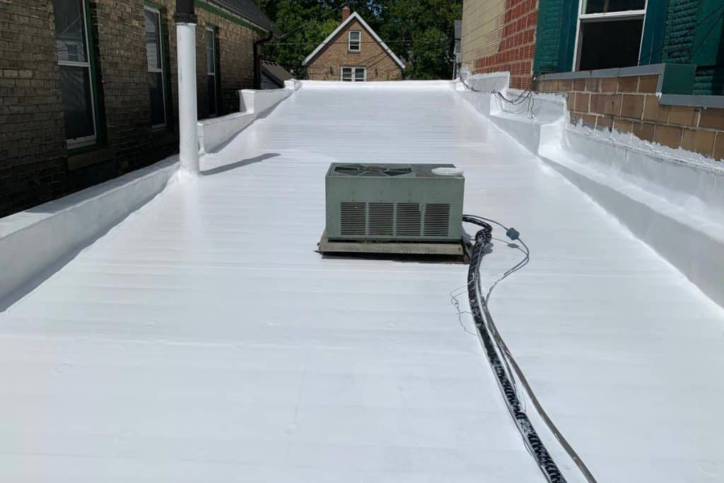 Silicone coating applied to a flat rubber membrane roof