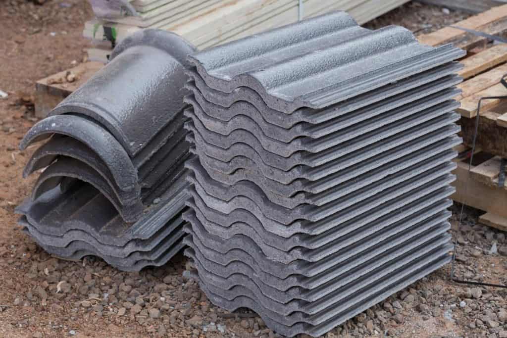 Stack of new concrete roof tile (gray color) at construction site