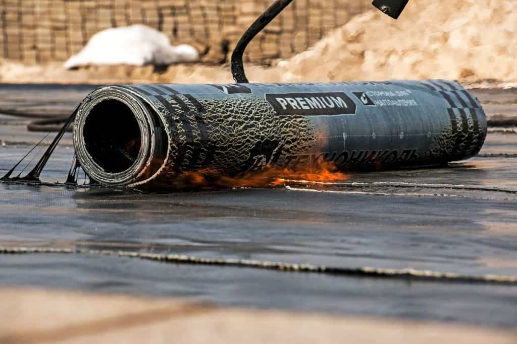 The process of installing roofing material using a blowtorch