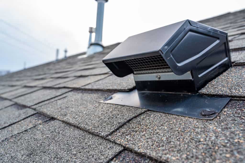 Vent flashing on top of a roof with asphalt roofing
