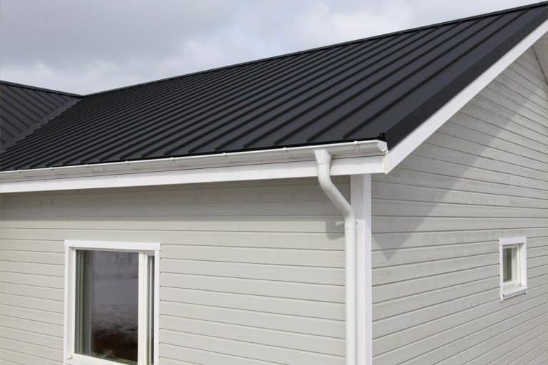 A wooden new house with black metal roofing, Black Metal Roof: What Are The Benefits?