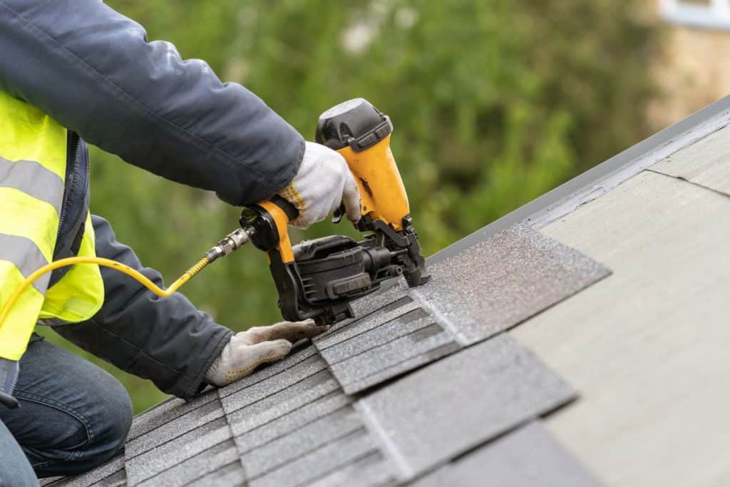 installing asphalt or bitumen tile on top of the roof under construction house