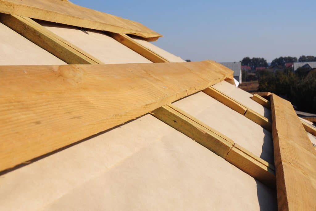 roof wooden beams, rafters, trusses with waterproofing membrane installation
