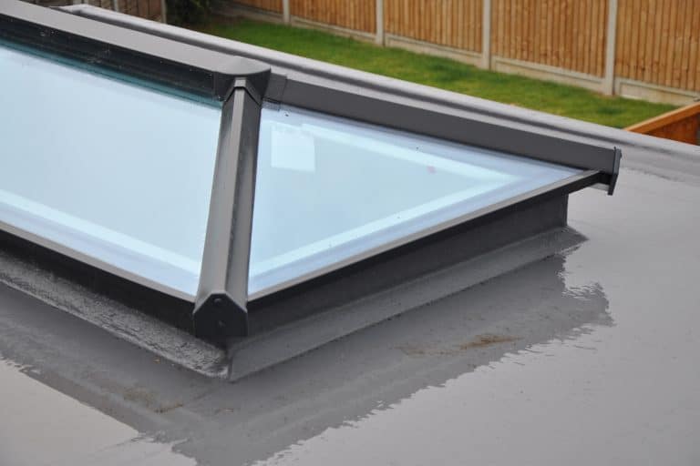 Grey flat roof window or light lantern close up area of detail. Wet day rain reflections - Are Roof Lanterns Outdated