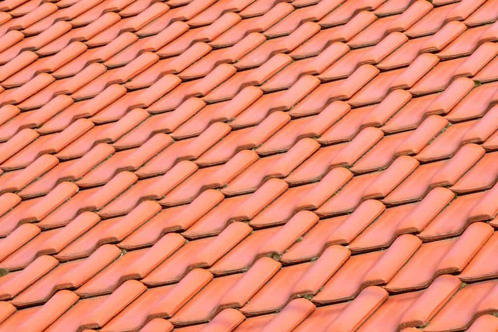 Light orange classic roof tiles, new roof covering, traditional roofing service concept.